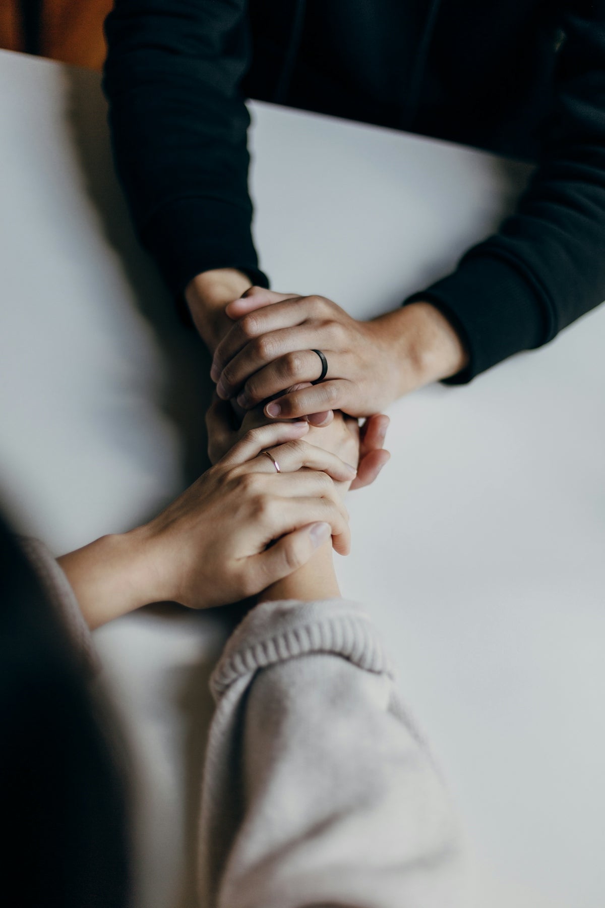 two people holding hands on table in comfort